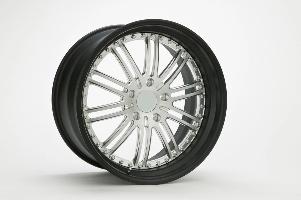 Close-up of alloy wheel and new tire in a studio shot
